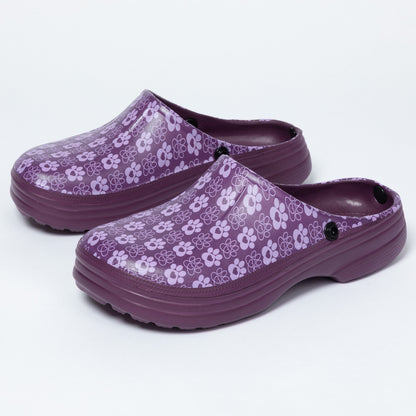 A pair of purple clogs with a light paw print pattern on the uppers and matching purple soles, shown against a plain white background.