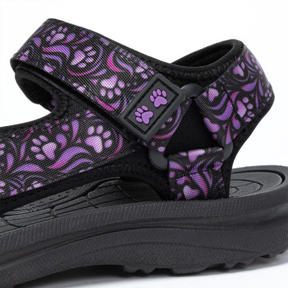 Black sandal with purple paw print pattern on a white background