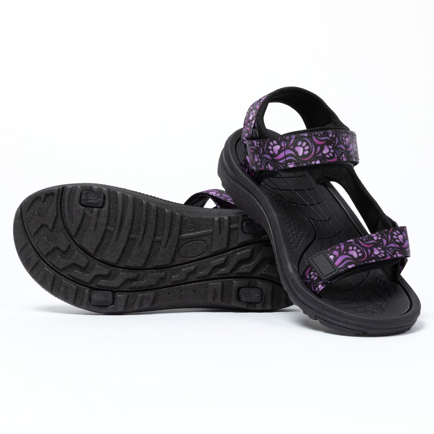 Black sandals with purple floral patterns on a white background