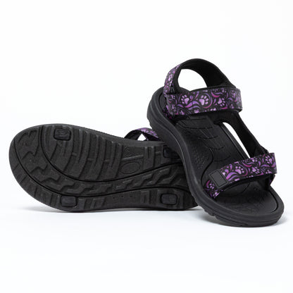 Black sandals with purple floral patterns on a white background