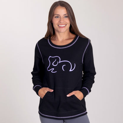 Woman smiling while wearing a black thermal long sleeve top with a playful purple cat design.