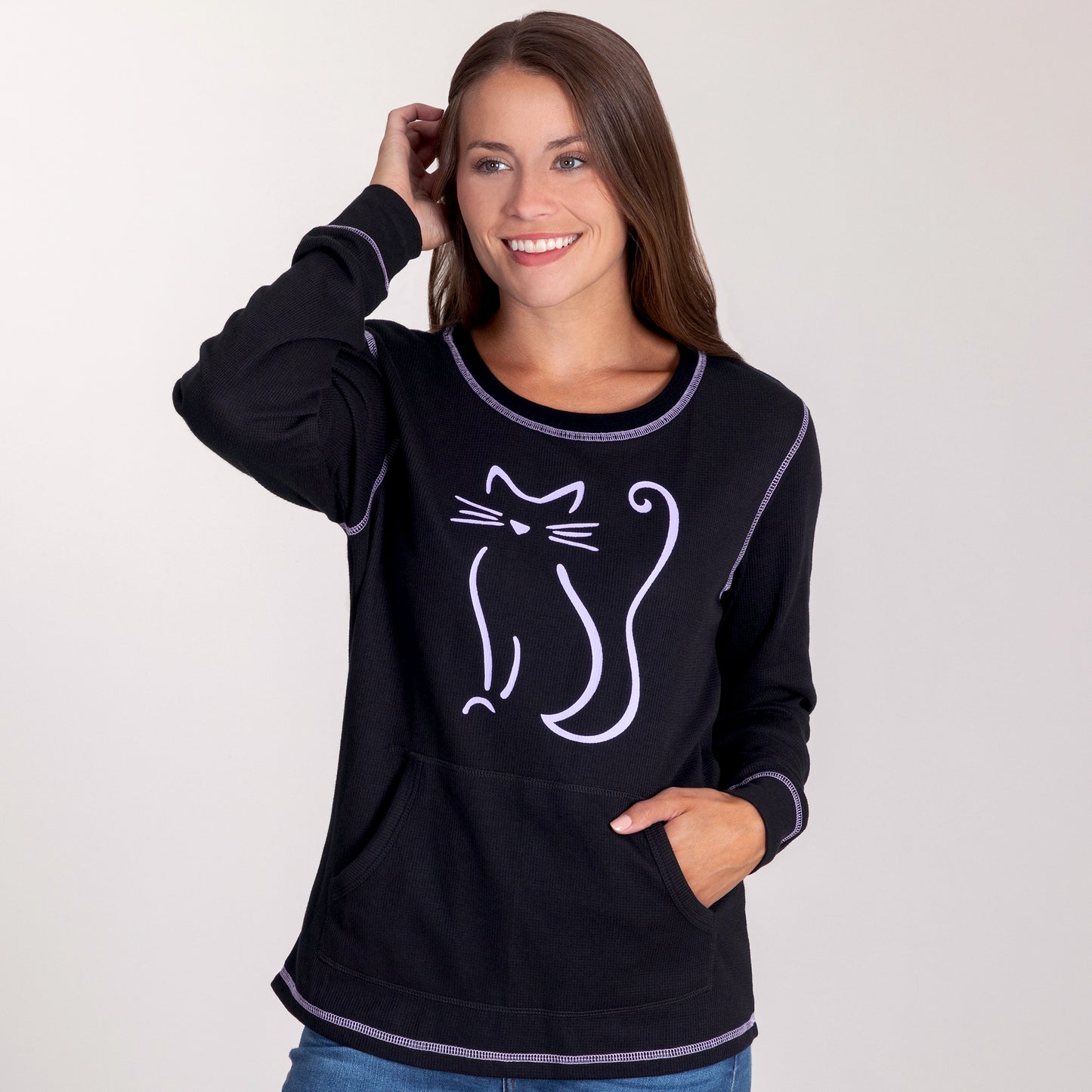Woman smiling while wearing a black long sleeve thermal tee featuring a cat design.