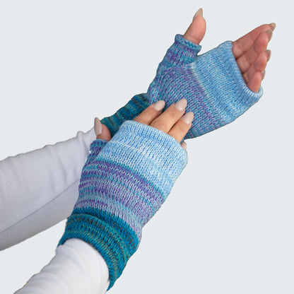 Blue and purple striped fingerless gloves worn by a person on a light gray background