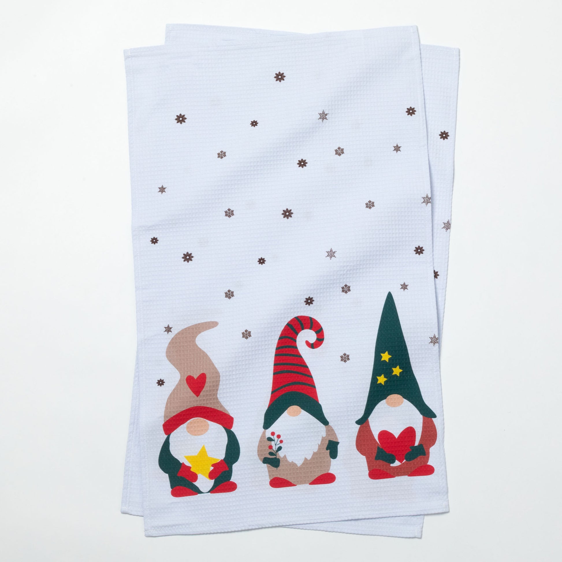 Two folded towels with Christmas-themed gnomes on a white background