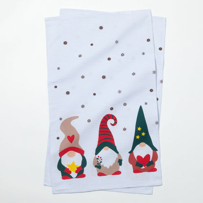 Two folded towels with Christmas-themed gnomes on a white background