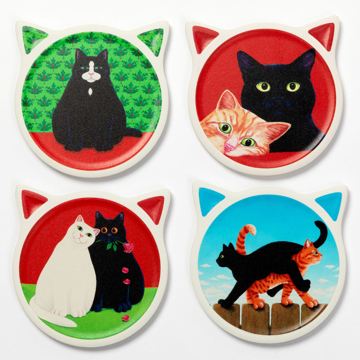 Four round cat-ear coasters arranged in a 2x2 grid on a white background. Each coaster features a different cat illustration: a black cat on green, a black cat and orange kitten on red, a white cat and black cat on red, and a black cat and orange tabby on blue.