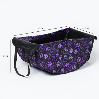 A pet carrier or basket-style pet bed with a purple and black floral paw-print pattern, shown with dimension lines and labels indicating 23 in length, 13.5 in width, and 14 in height.