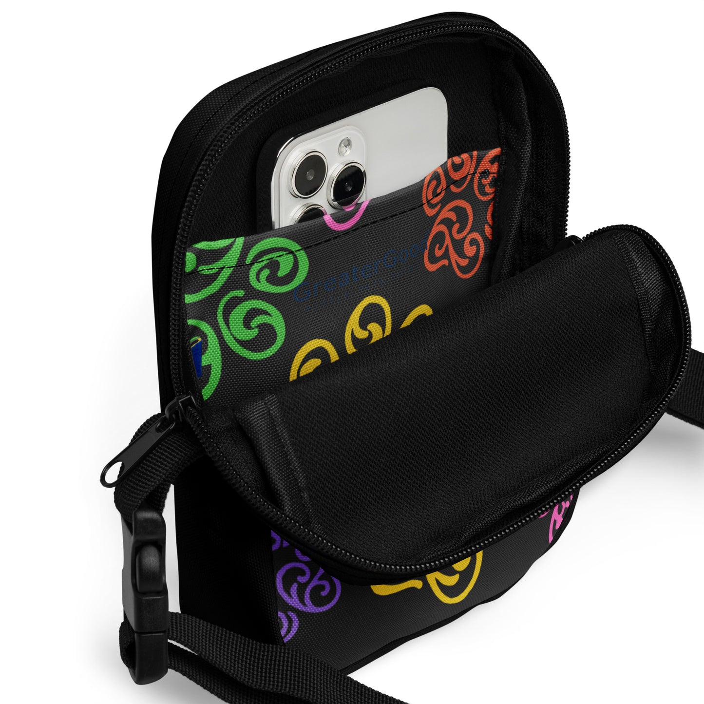 Close up of a pocket inside a Black crossbody bag with colorful patterns on a white background