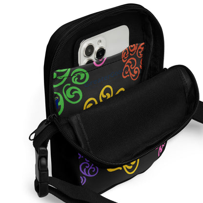 Close up of a pocket inside a Black crossbody bag with colorful patterns on a white background