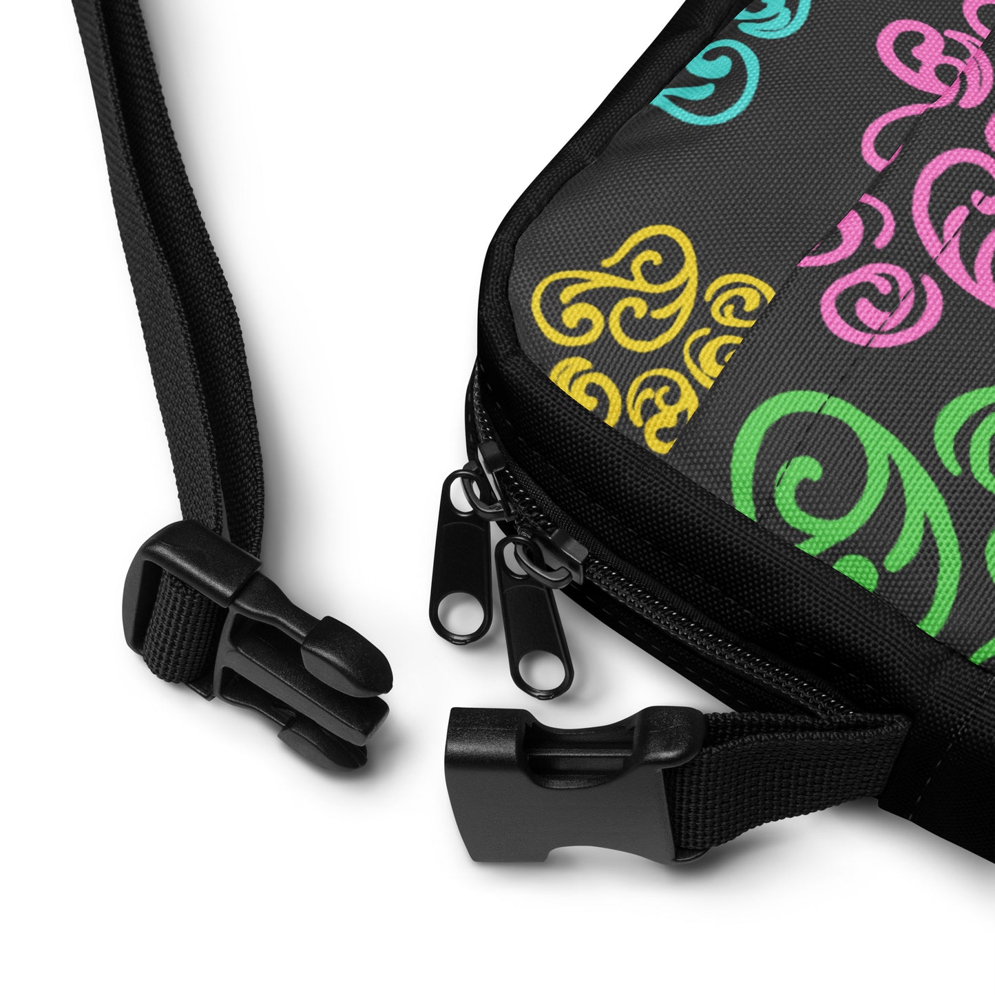 Closeup of a buckle on a Black bag with colorful patterns on a white background