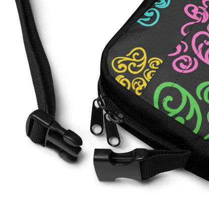 Closeup of a buckle on a Black bag with colorful patterns on a white background