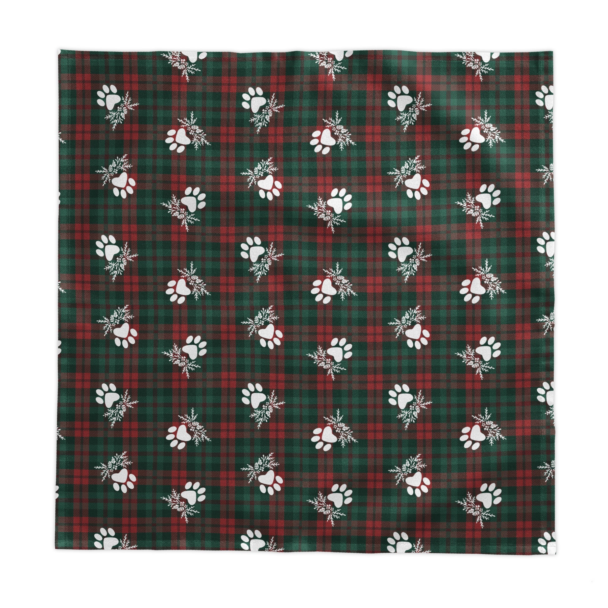 a green and red plaid tablecloth with white paw prints on a white background