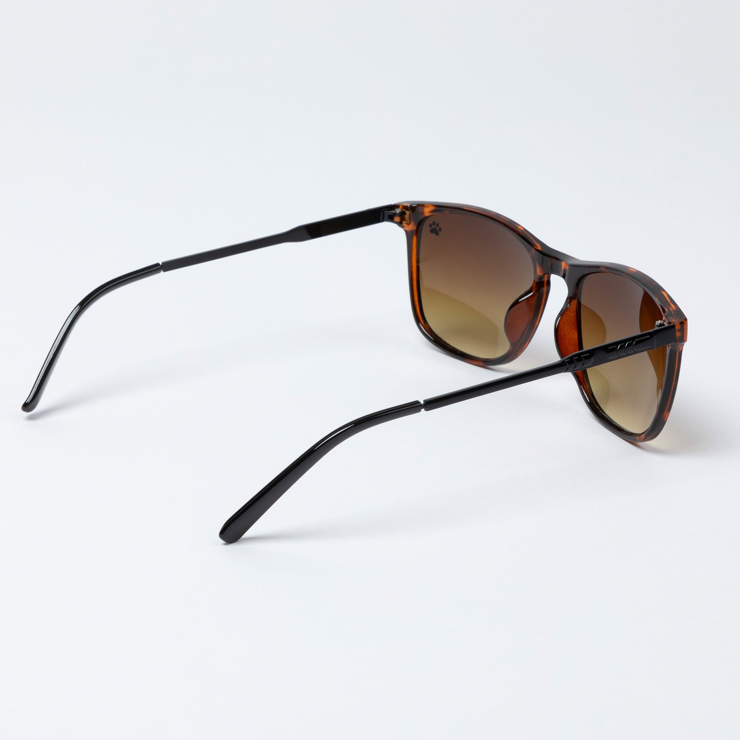 Sunglasses with gold frame and brown lenses on a white background