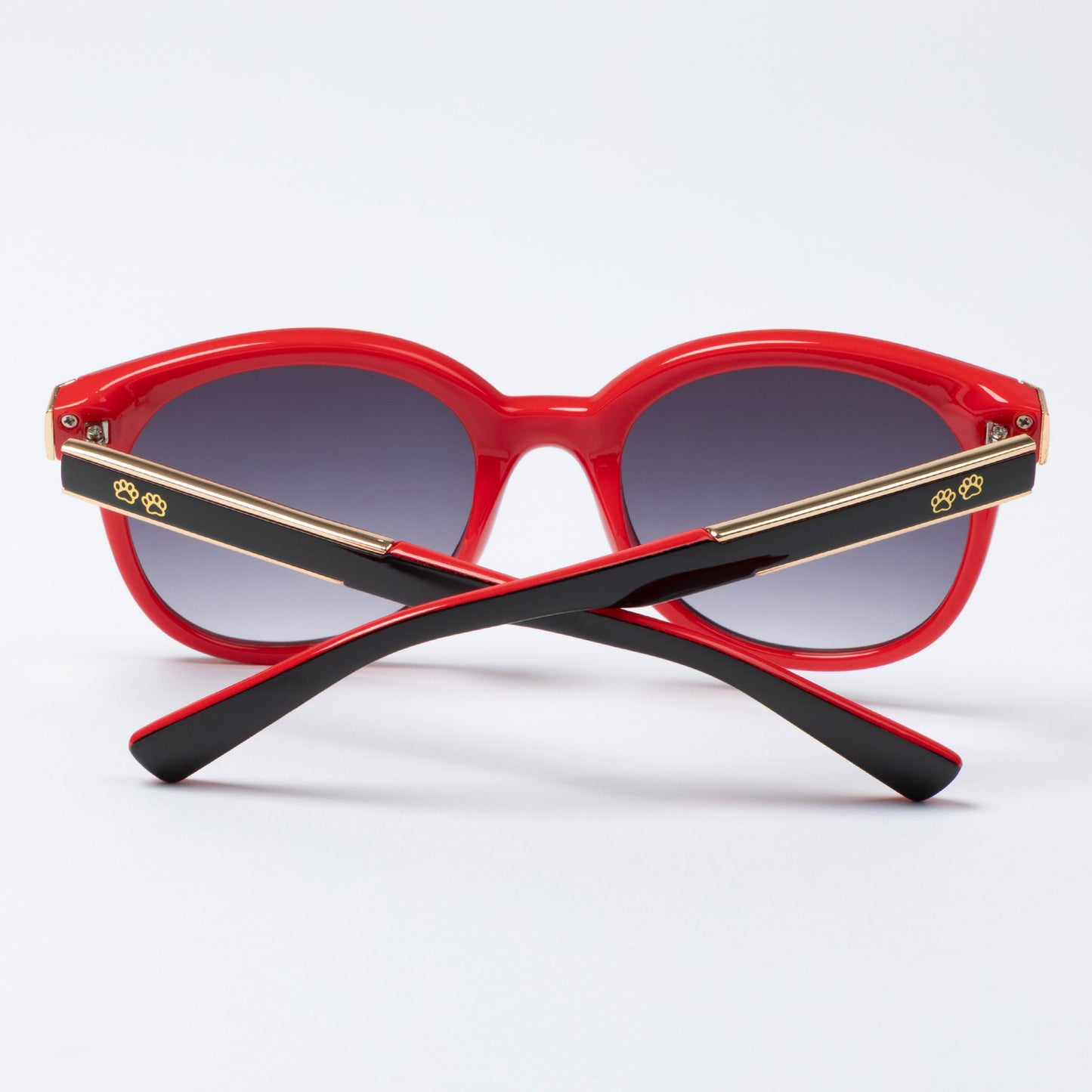 Red sunglasses with black arms on a white background