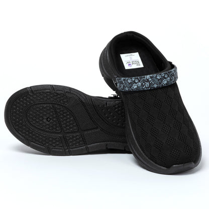 Black slip-on shoes with textured sole on a white background