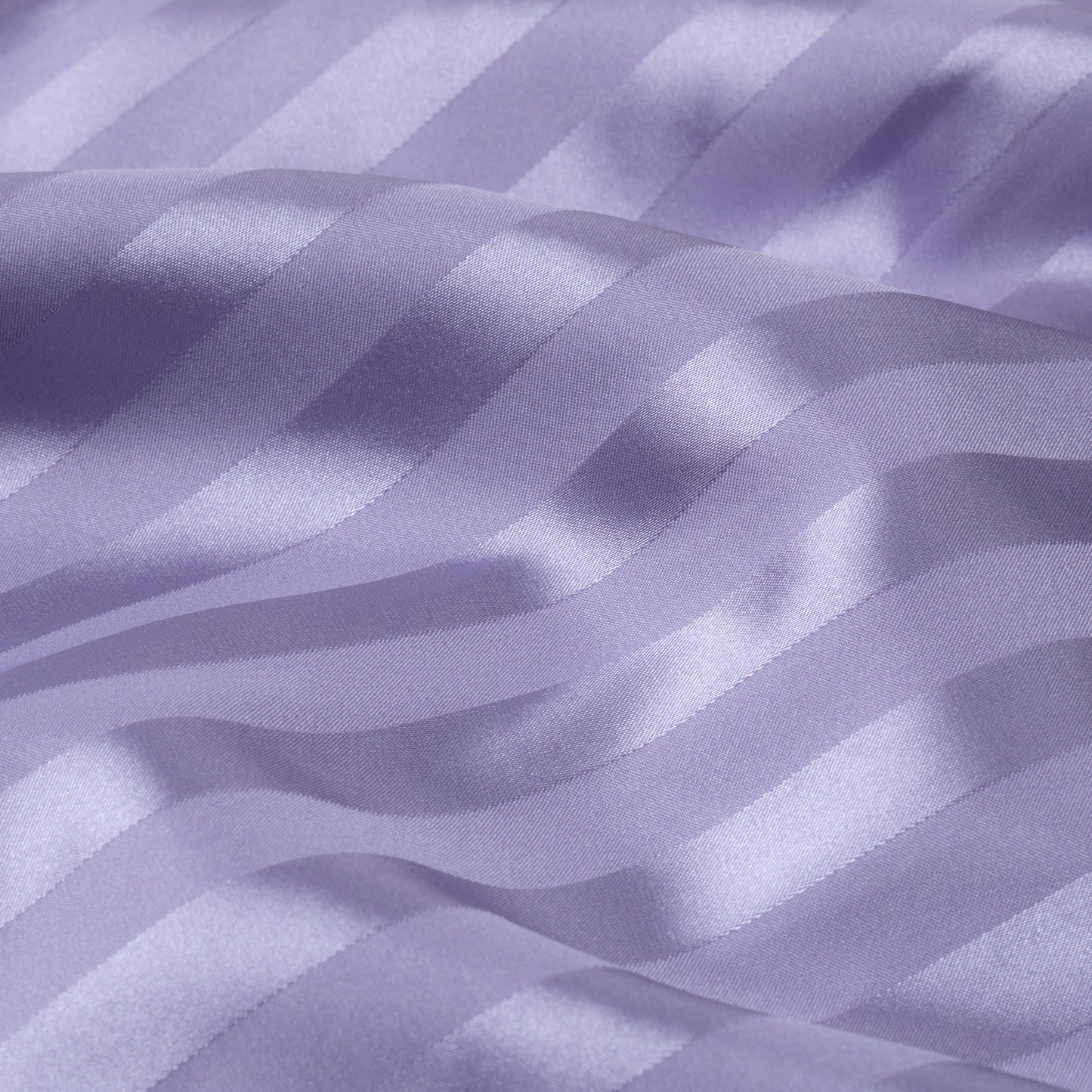 Close-up of purple satin fabric with stripes