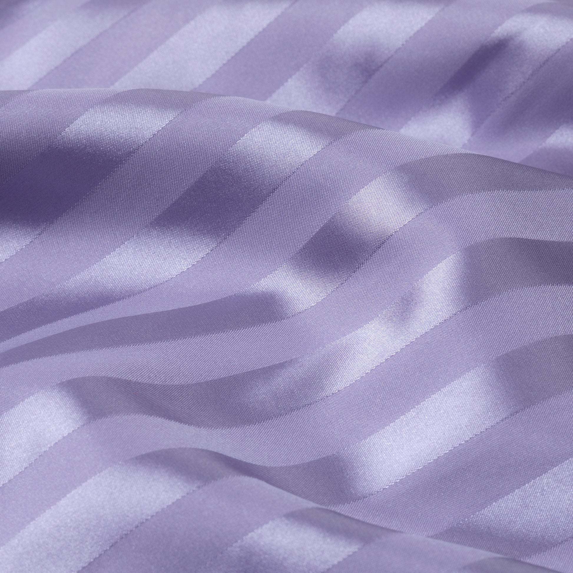 Close-up of purple satin fabric with stripes