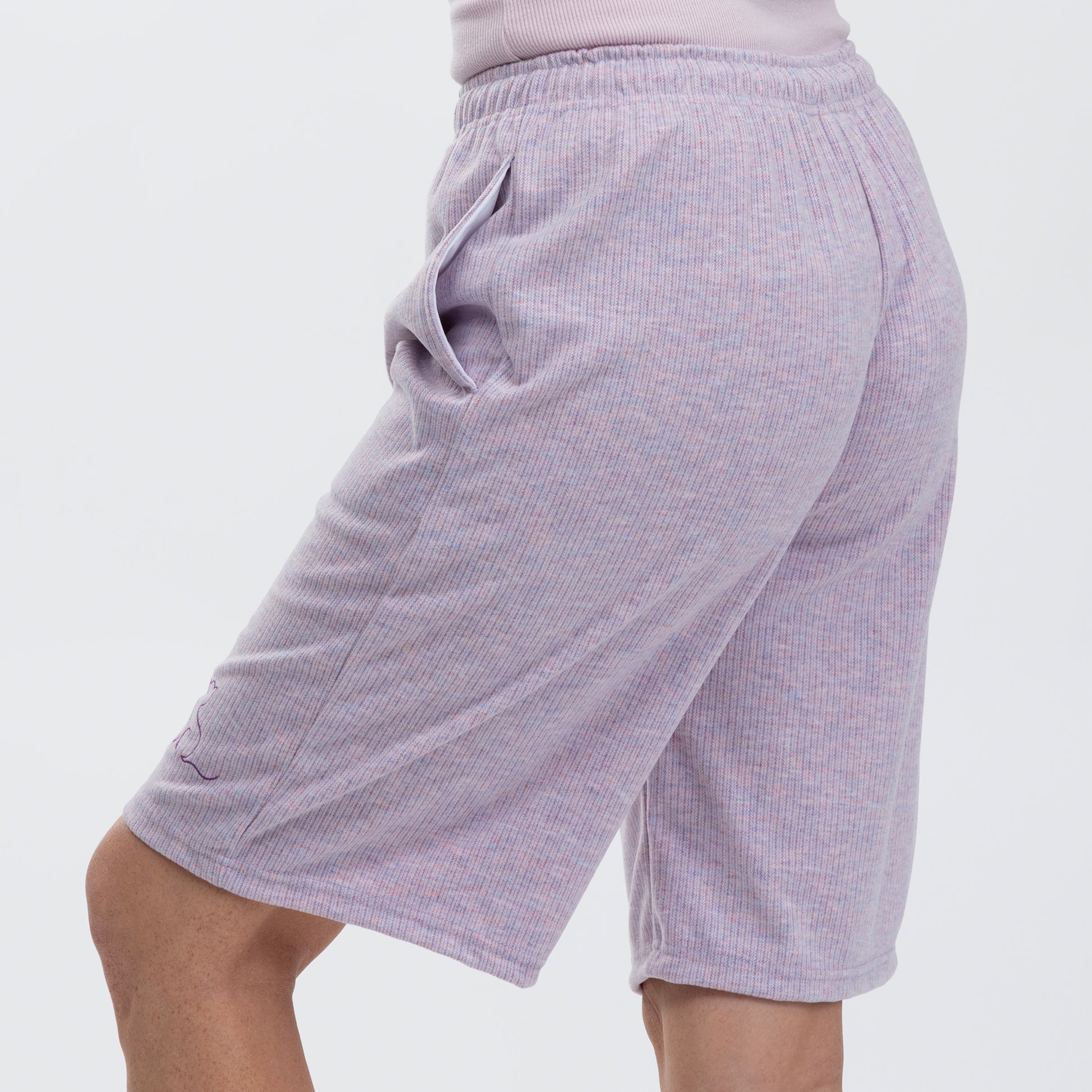 Purple rib knit shorts on a plain background.