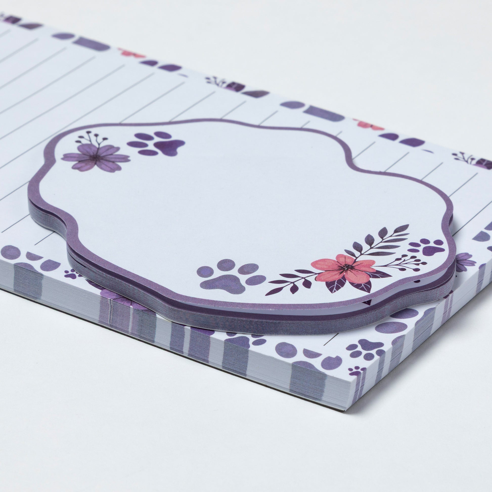 Notepad with floral and paw print design on a white background