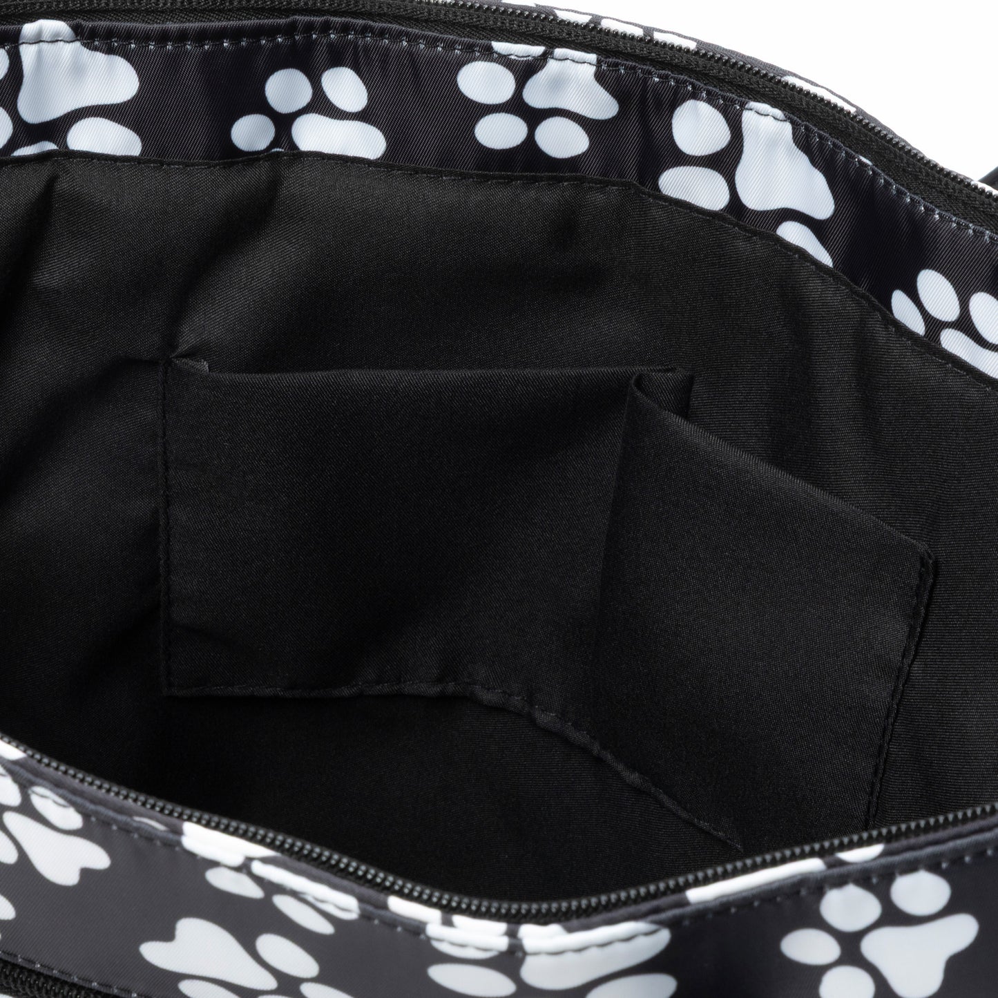 Black tote bag with white paw prints on a black background