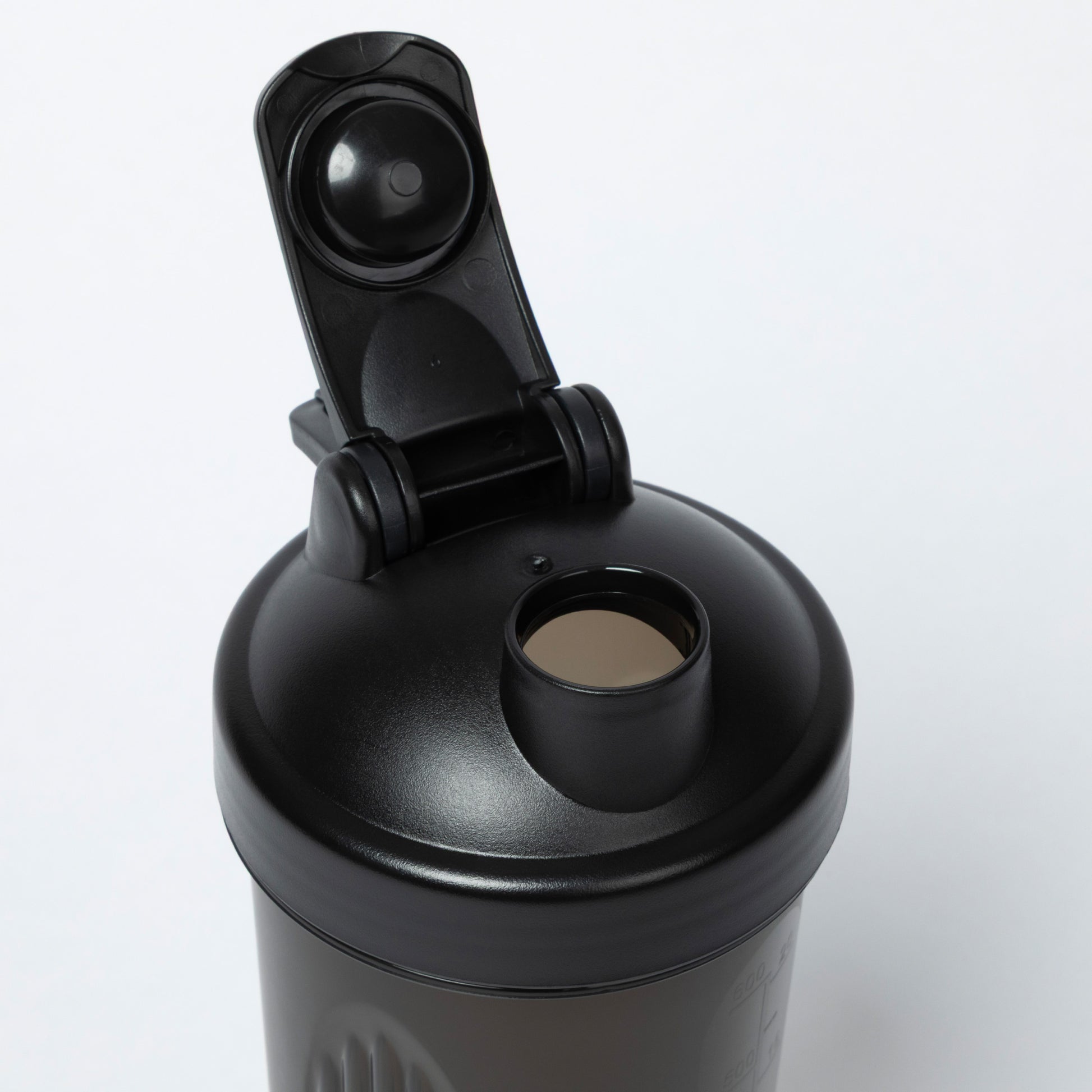 Black shaker bottle with a clip on lid against a white background