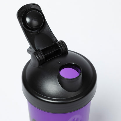 Purple shaker bottle with black cap on a white background