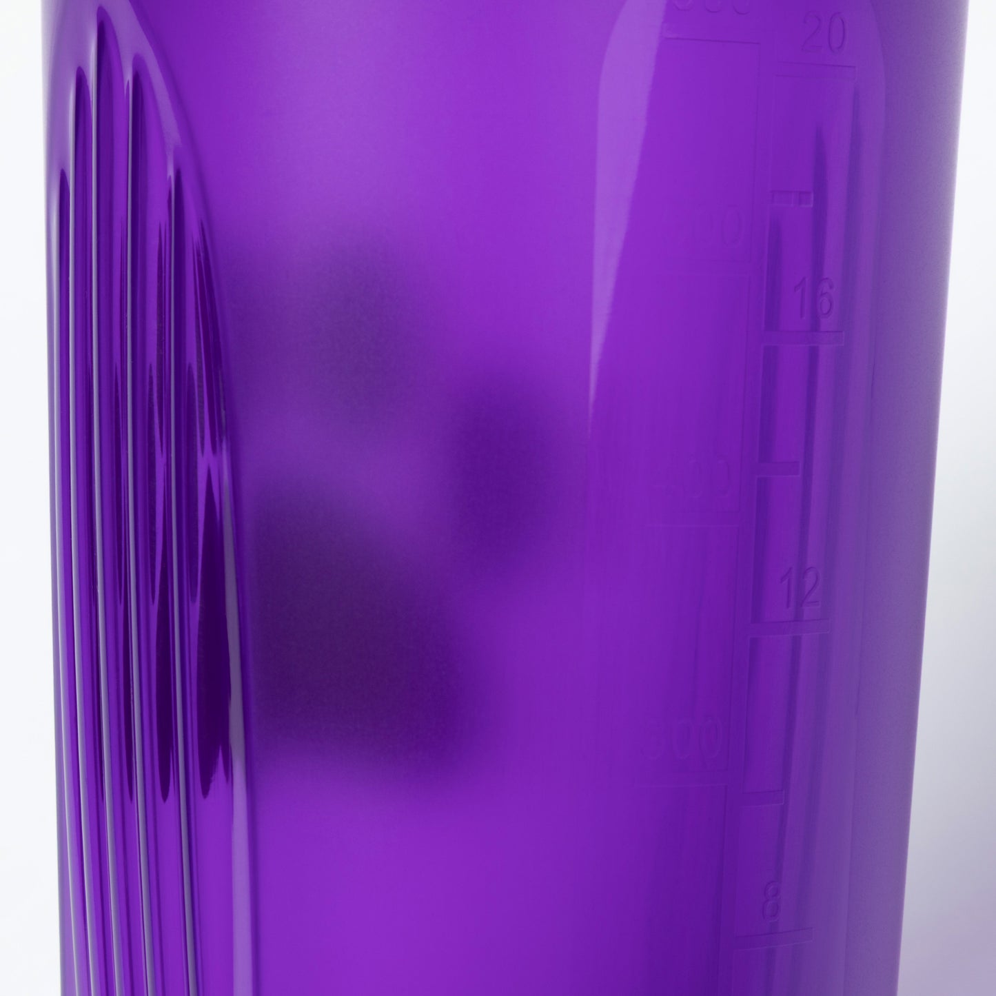 Close-up of a purple tumbler with measurement markings on a white background
