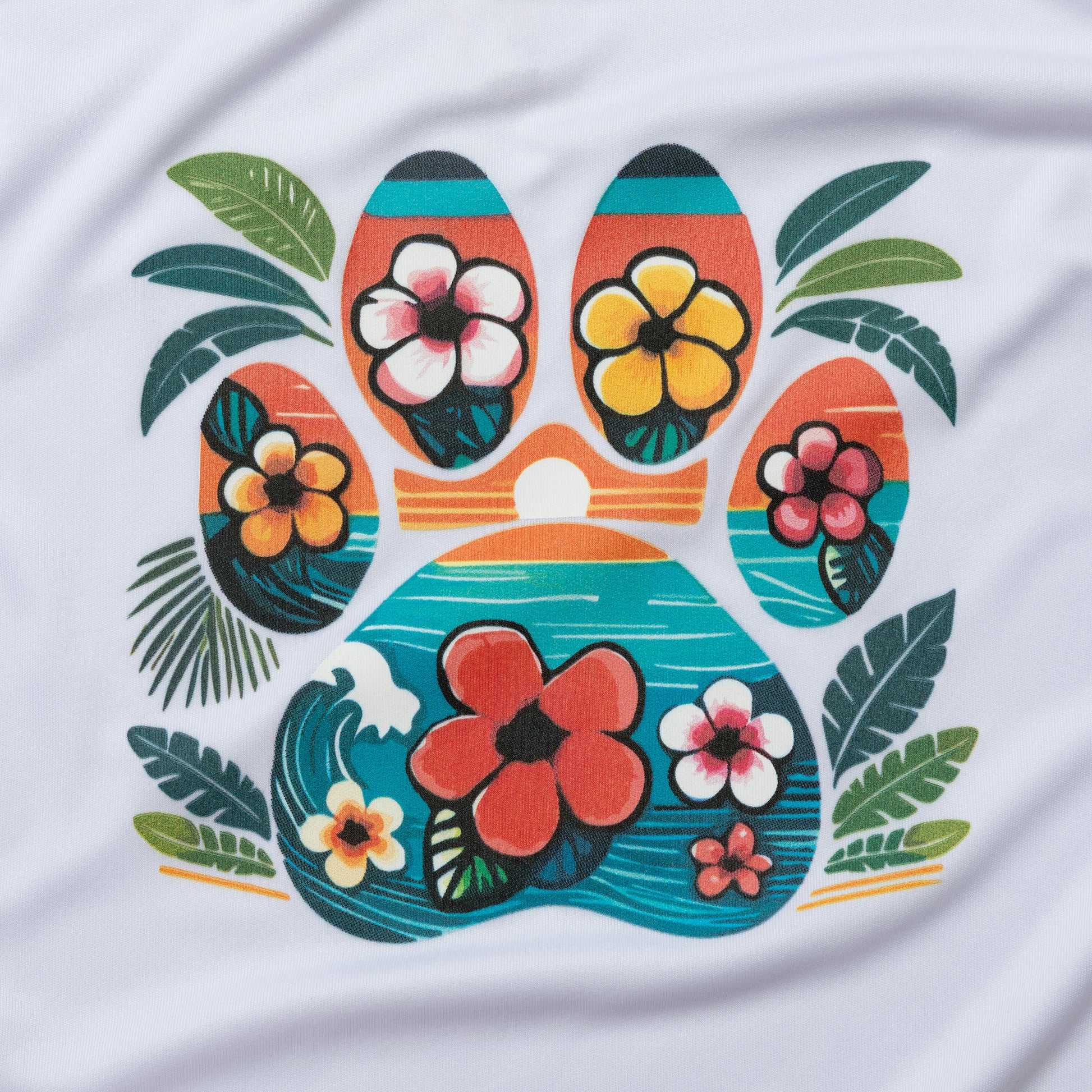 A close-up of a white fabric surface featuring a colorful tropical paw print graphic with hibiscus flowers and palm leaves.