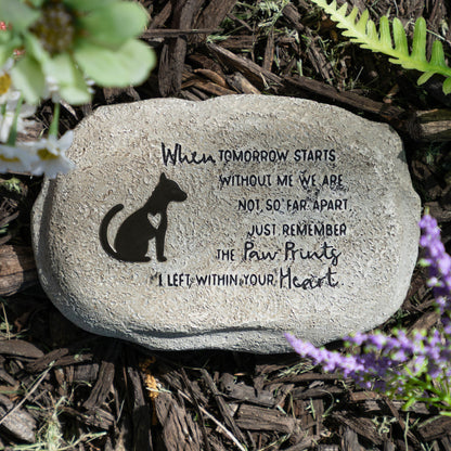 Decorative stone with a dog silhouette and engraved text on a natural background