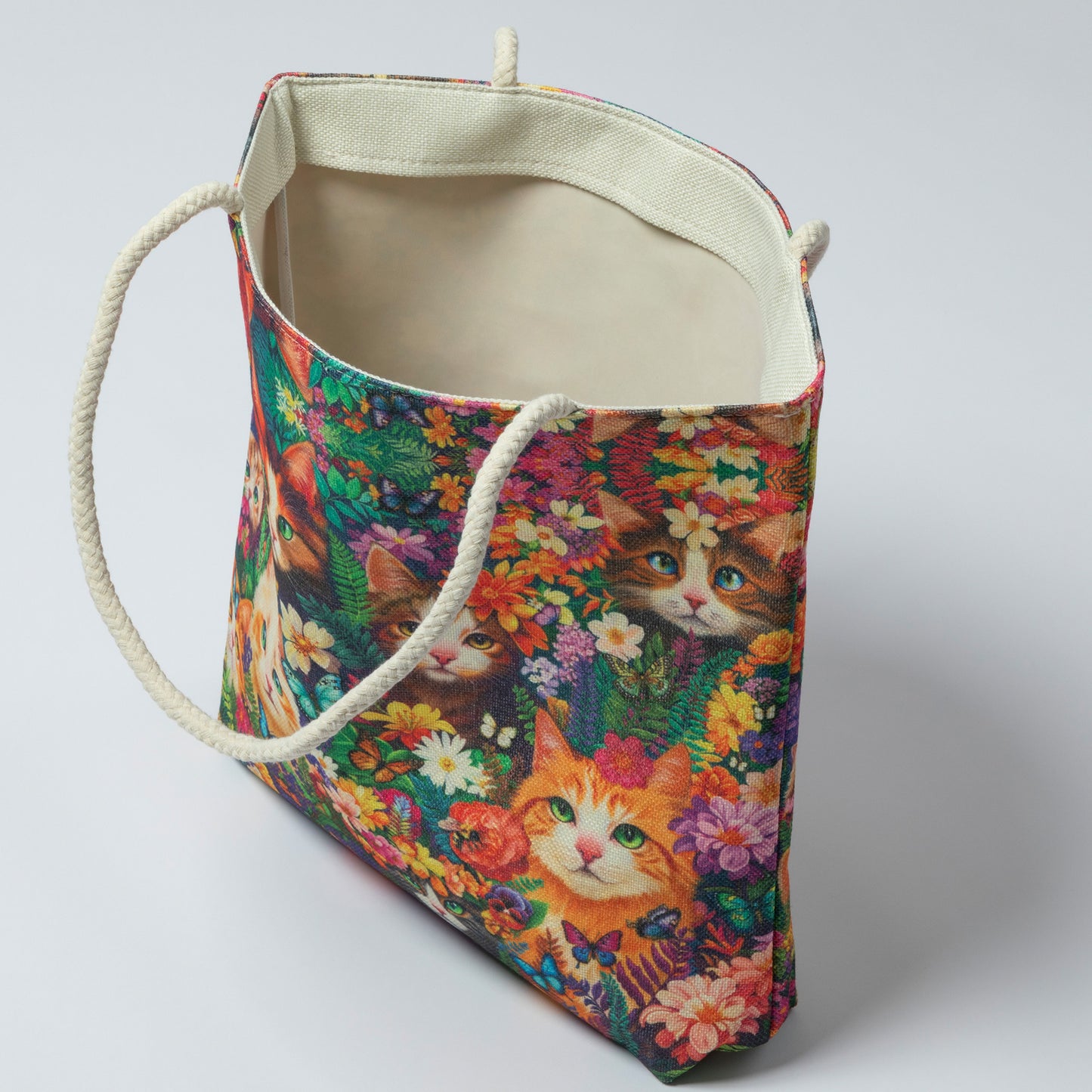 Colorful tote bag with cat and floral pattern on a white background
