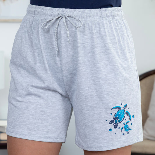 Gray shorts with a blue turtle design on a neutral background