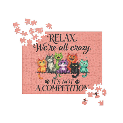 A completed jigsaw puzzle featuring a pink background with the text 'RELAX We're all crazy IT'S NOT A COMPETITION' .