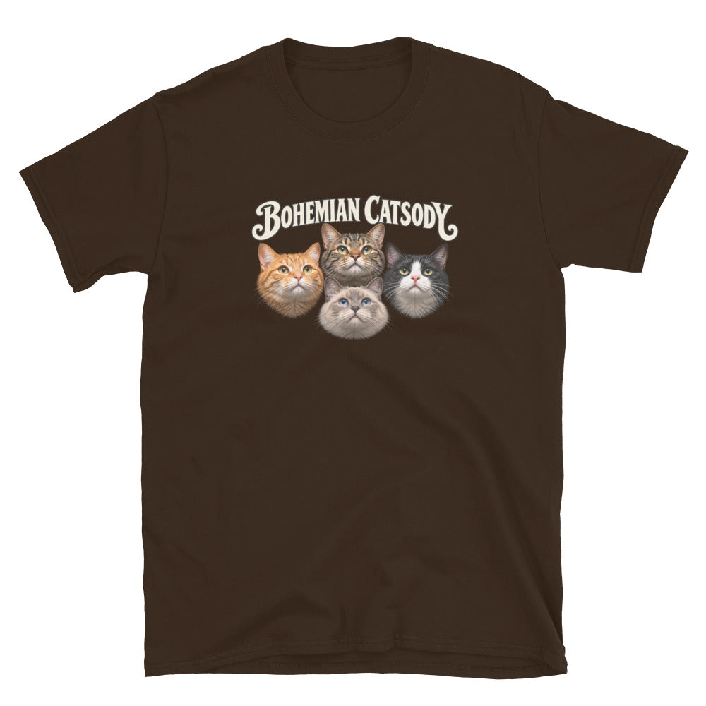 A dark brown short-sleeve crewneck t-shirt featuring a graphic print of four different cat faces with the text 'BOHEMIAN CATSODY' above them, displayed on a clean white background.
