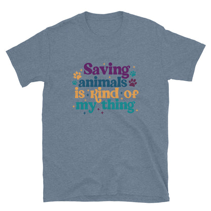 heathered indigo blue shirt that reads Saving Animals is kind of my Thing with several paw print and sparkle images in a purple, yellow and blue font.
