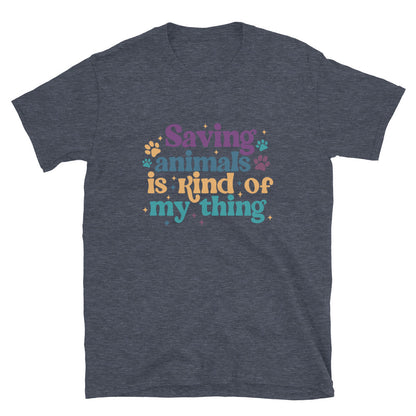 heathered navy shirt that reads Saving Animals is kind of my Thing with several paw print and sparkle images in a purple, yellow and blue font.