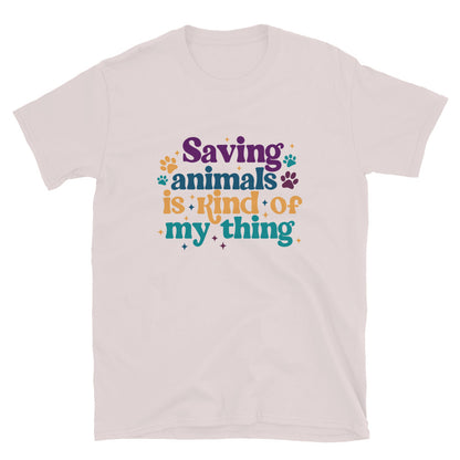ice gray  shirt that reads Saving Animals is kind of my Thing with several paw print and sparkle images in a purple, yellow and blue font.