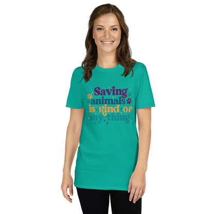 Woman in teal shirt that reads Saving Animals is kind of my Thing with several paw print and sparkle images in a purple, yellow and blue font.