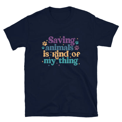 Navy shirt that reads Saving Animals is kind of my Thing with several paw print and sparkle images in a purple, yellow and blue font.