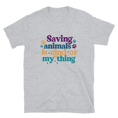 sports grey shirt that reads Saving Animals is kind of my Thing with several paw print and sparkle images in a purple, yellow and blue font.