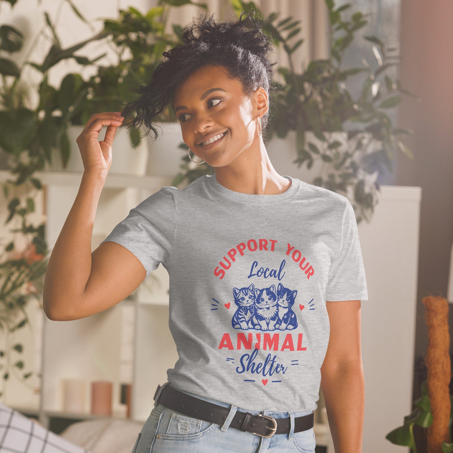 Woman wearing a t-shirt with an animal shelter message in a home setting