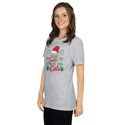 Woman wearing a light gray Short Sleeve Shirt that reads Dear Santa Bring Me More Cats. Featuring a santa hat, cat ears and cat whiskers with paw prints