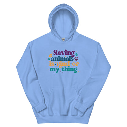 Light blue Hooded Sweatshirt that reads Saving Animals is kind of my Thing with several paw print and sparkle images in a purple, yellow and blue font.
