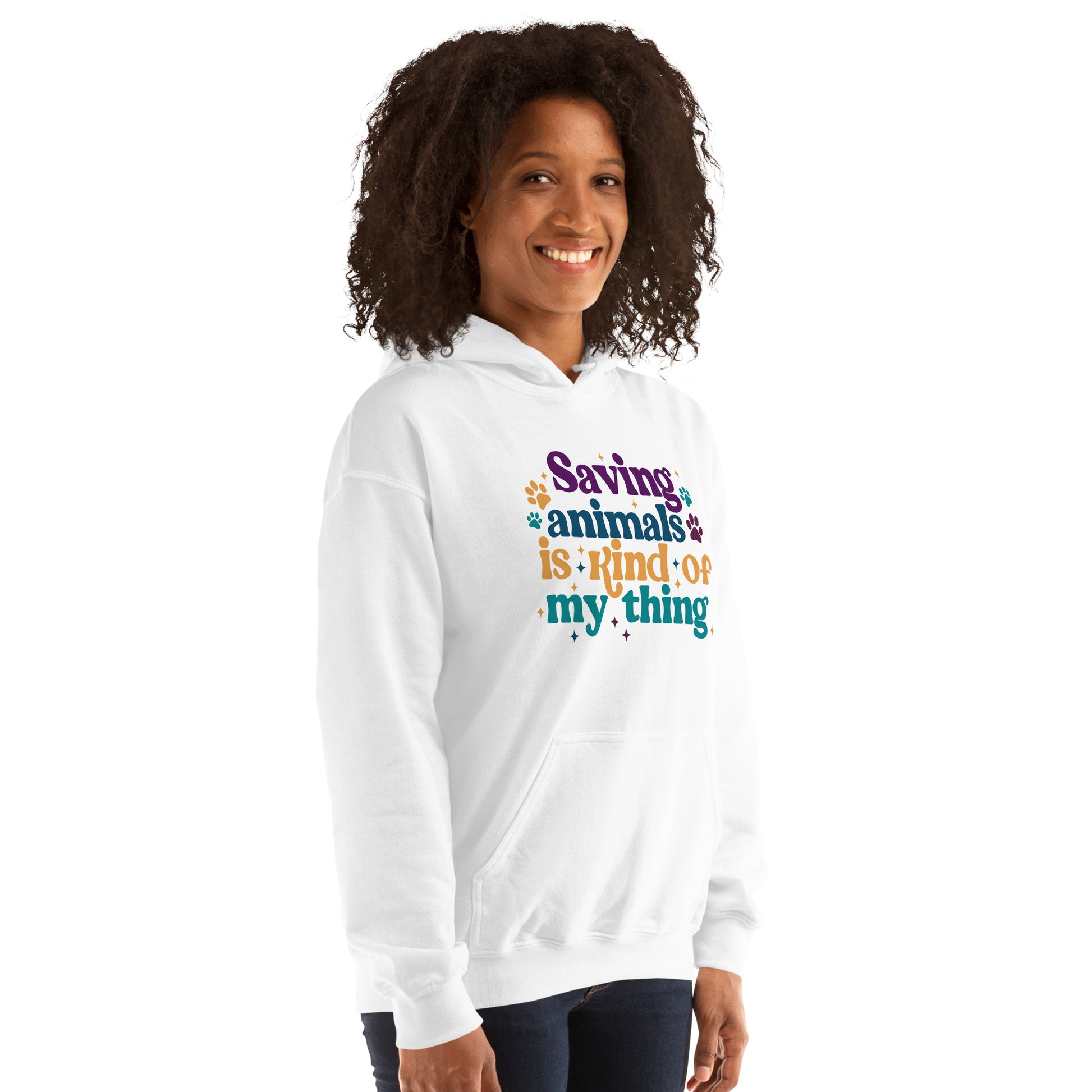 Woman wearing a white Hooded Sweatshirt that reads Saving Animals is kind of my Thing with several paw print and sparkle images in a purple, yellow and blue font.