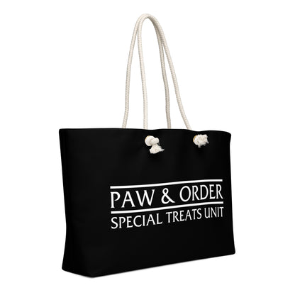 Right side view Black tote bag with tan rope handles. Design is black with white lettering that reads: Paw & Order- Special Treats Unit